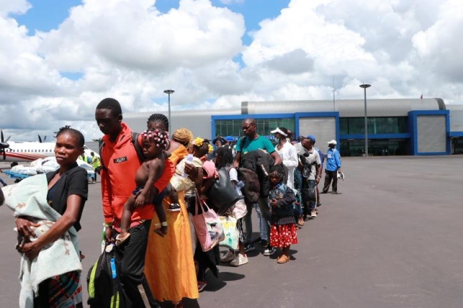 Returning refugees boarding a plane to the DRC during voluntary repatriation